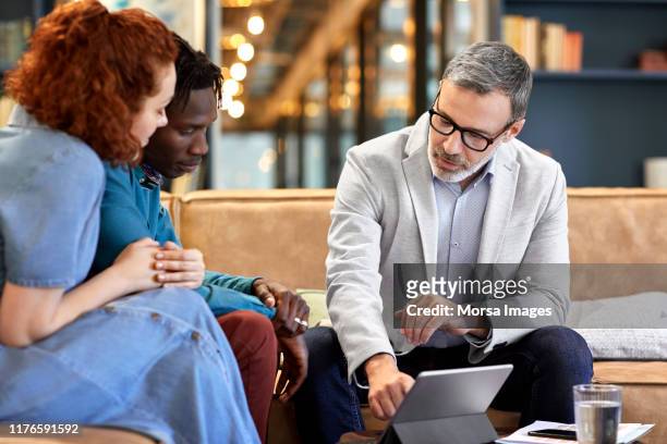 financial advisor planning with clients at office - banking stock pictures, royalty-free photos & images