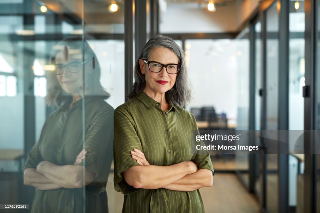 Confident mature businesswoman with arms crossed