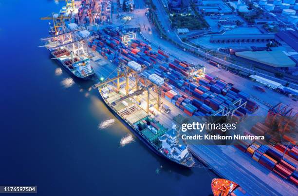 containers yard in port congestion with ship vessels are loading and discharging operations of the transportation in international port.shot from drone. - singapore port stock pictures, royalty-free photos & images