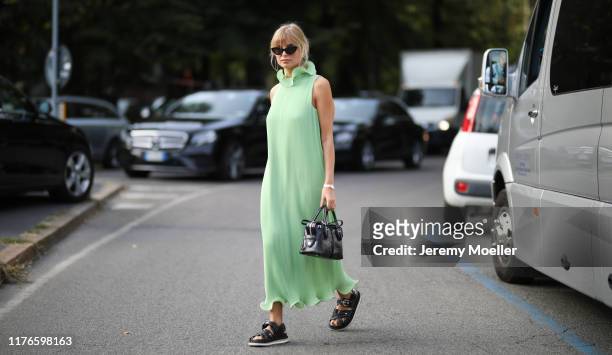 Xenia Adonts wearing a complete Tods look and poses outside the Tods show during Milan Fashion Week Spring/Summer 2020 on September 20, 2019 in...