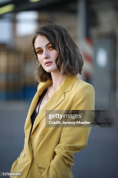 Vanessa Stanat wearing a yellow suit, Dr. Martens and a MCM bag on September 21, 2019 in Berlin, Germany.