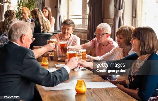 friends together in a british pub - gastro pub stock pictures, royalty-free photos & images