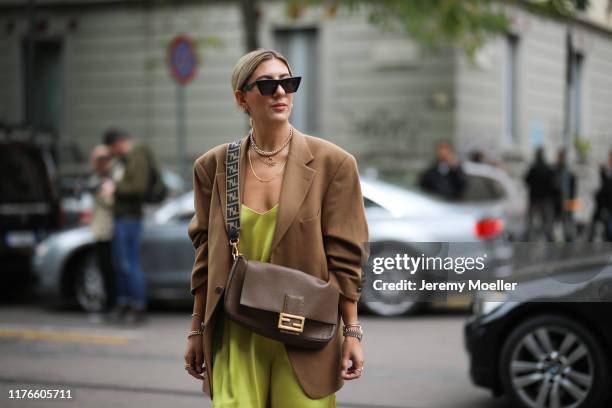 Aylin Koenig wearing a Fendi baguette and overknees and poses outside the Fendi show during Milan Fashion Week Spring/Summer 2020 on September 19,...