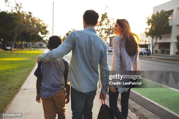 multi racial family with adoptive children spending time together at the park - adoption stock pictures, royalty-free photos & images