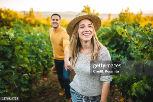 let me lead you through vineyard - millennial generation couple stock pictures, royalty-free photos & images