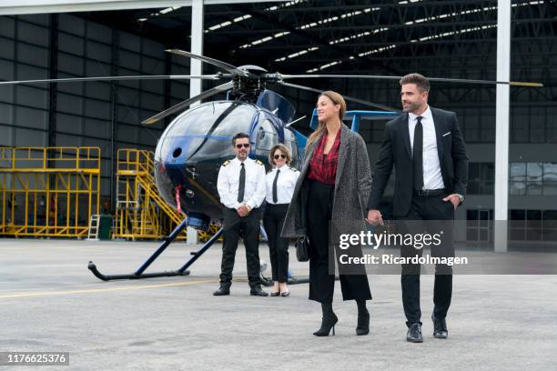 couple getting off their helicopter - helicopter money stock pictures, royalty-free photos & images