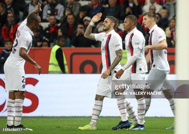 Paris Saint-Germain's Argentine forward Mauro Icardi is congratulated by Paris Saint-Germain's French defender Abdou Diallo after scoring a goal...