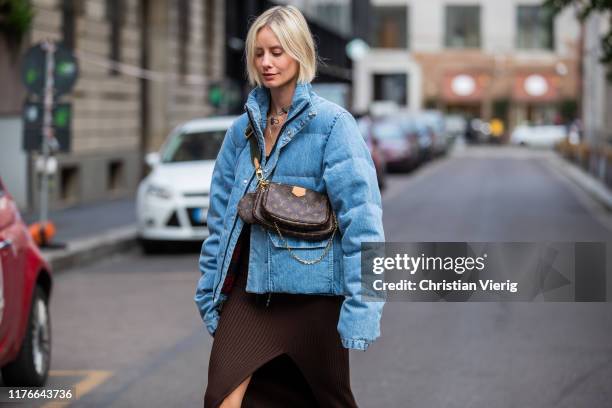 Lisa Hahnbueck is seen wearing blue Unravel down feather jacket in denim, H&M trend dress with slit in brown, Louis Vuitton multi puchette...