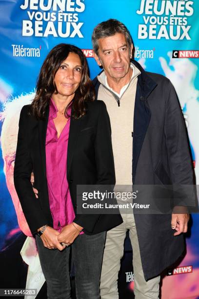 Doctor Michel Cymes and his wife Nathalie Cymes attend the "Vous Etes Jeunes, Vous êtes Beaux" premiere at Cinema Gaumont Opera on September 23, 2019...