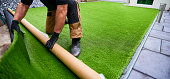 Rolling artificial grass out to fit
