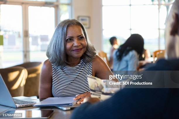 senior woman discusses retirement planning - coffee shop couple stock pictures, royalty-free photos & images