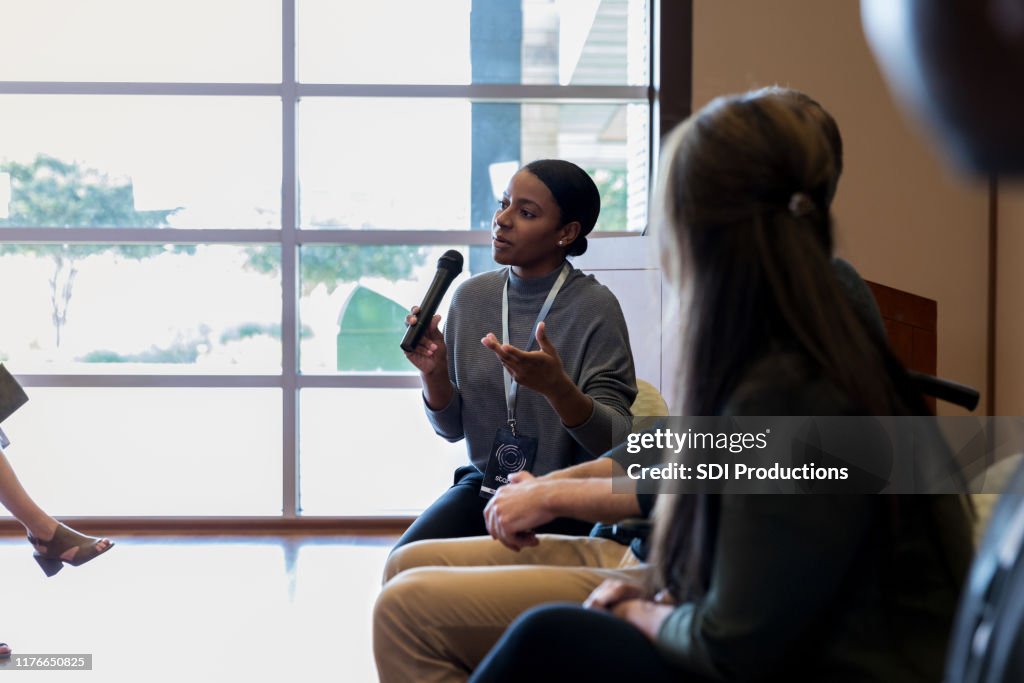 Businesswoman talks during panel discussion