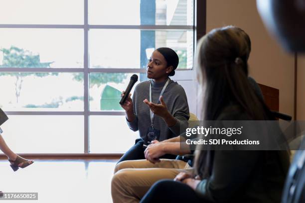 businesswoman talks during panel discussion - panelist stock pictures, royalty-free photos & images