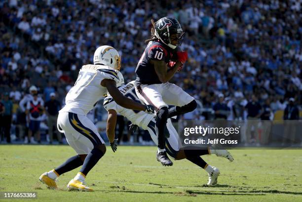 DeAndre Hopkins of the Houston Texans is pursued by Jaylen Watkins of the Los Angeles Chargers at Dignity Health Sports Park on September 22, 2019 in...