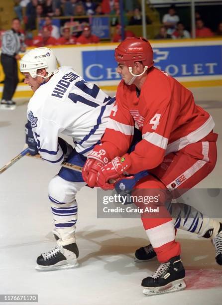 Mike Hudson of the Toronto Maple Leafs skates against Jamie Pushor of the Detroit Red Wings during NHL preseason game action on October 1, 1995 at...