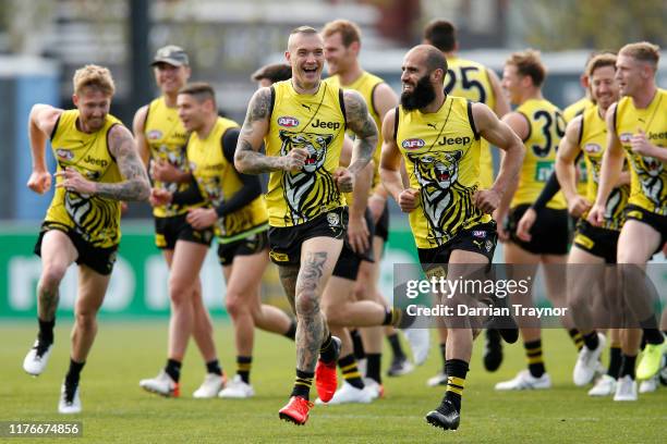 Dustin Martin and Bachar Houli of the Tigers share a joke during a Richmond Tigers AFL training session at Punt Road Oval on September 24, 2019 in...