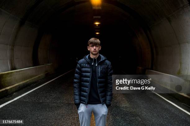 teenage boy at the tunnel entrance - serious teenager boy stock-fotos und bilder