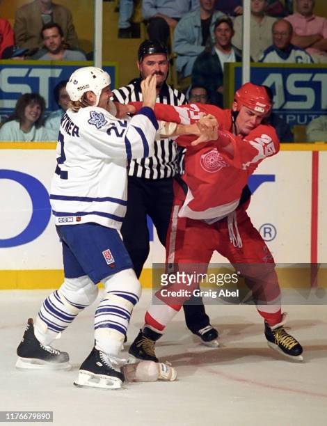 Darren McCarty of the Detroit Red Wings skates against Ken Baumgartner of the Toronto Maple Leafs during NHL preseason game action on October 1, 1995...