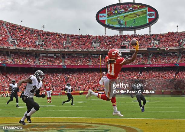 Wide receiver Demarcus Robinson of the Kansas City Chiefs catches a touchdown pass against cornerback Brandon Carr of the Baltimore Ravens during the...