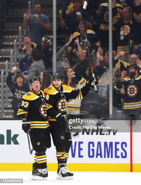 Jake DeBrusk of the Boston Bruins celebrates with Brad Marchand after scoring the game winning goal during overtime of the preseason game between the...