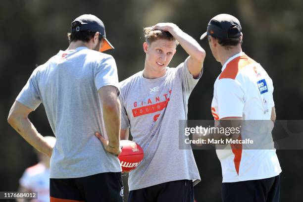 Lachie Whitfield of the Giants talks with head coach Leon Cameron during a Greater Western Sydney Giants AFL training session at the WestConnex...