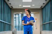Registered nurse walking on sky walk of hospital