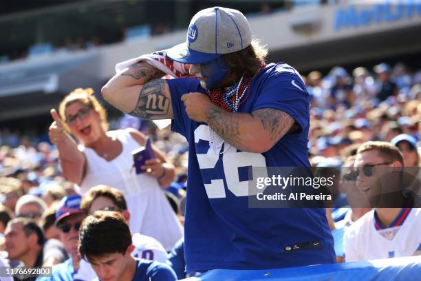 Fan of the New York Giants shows off a team logo tattoo during the second half of the game between the New York Giants and the Buffalo Bills at...