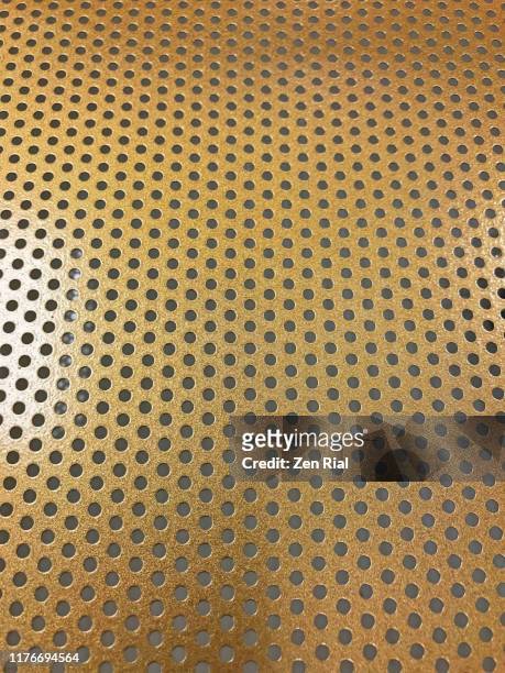 gold colored metal with small holes - metal mesh - geperforeerd stockfoto's en -beelden