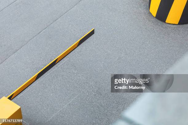 high angle view of parking barrier at parking lot. - parking entrance stock pictures, royalty-free photos & images