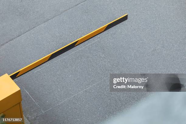 high angle view of parking barrier at parking lot. - construction barrier stock pictures, royalty-free photos & images