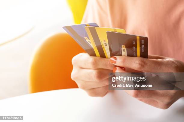 cropped shot view of female hands holding her credit cards. - debt collector stock pictures, royalty-free photos & images