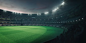 Stadium lights and empty green grass field with fans around, perspective tribune view