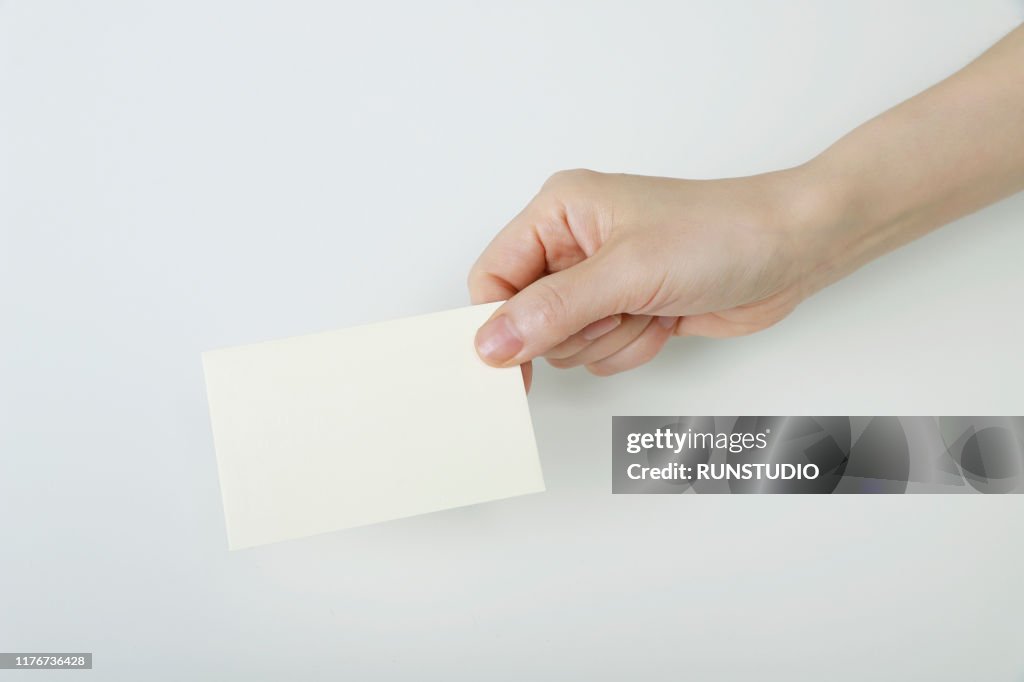 Woman holding business card