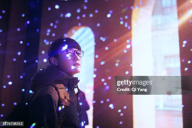 light projected on young man face - thinking man cloud stockfoto's en -beelden