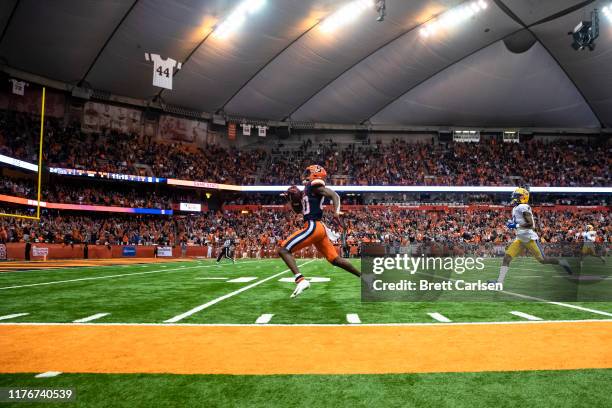 Taj Harris of the Syracuse Orange runs with the ball on a touchdown reception during the third quarter against the Pittsburgh Panthers at the Carrier...