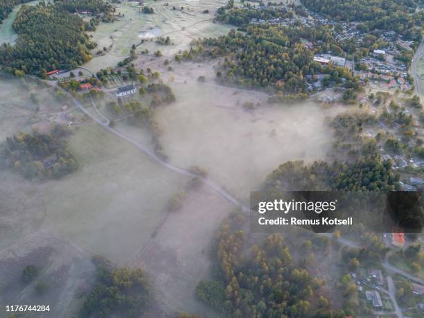 aerial view over foggy rural small town - nordic sunrise stock pictures, royalty-free photos & images