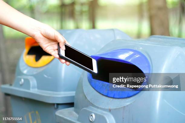 woman throwing a phone into the trash - throwing phone stock pictures, royalty-free photos & images