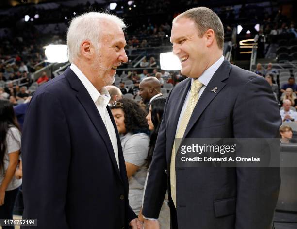 Gregg Popovich head coach of the San Antonio Spurs and Taylor Jenkins head coach of the Memphis Grizzlies talk before a preseason NBA game held at...