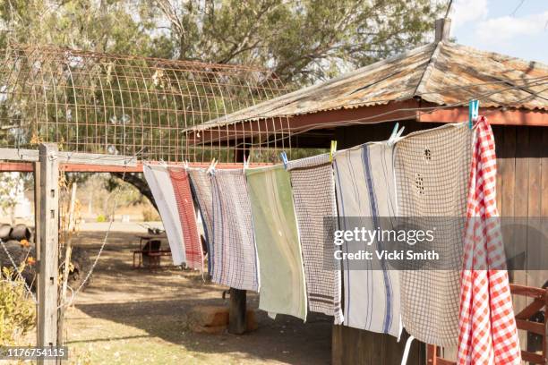 washing hanging on a old wooden post washing line - iron appliance stock pictures, royalty-free photos & images