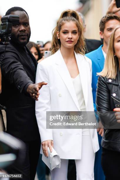 Barbara Palvin wears a white jacket, outside the Boss show during Milan Fashion Week Spring/Summer 2020 on September 22, 2019 in Milan, Italy.