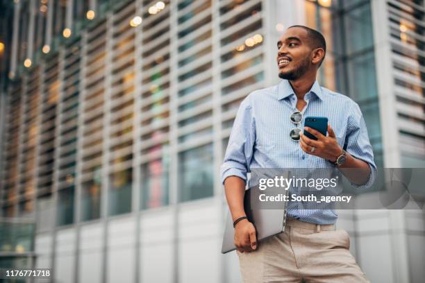 black businessman using phone - smart casual stock pictures, royalty-free photos & images