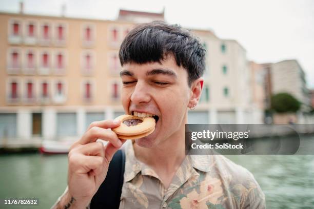 enjoying a sweet treat - one man only stock pictures, royalty-free photos & images