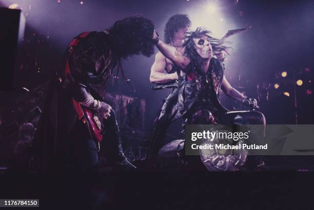 American rock singer Alice Cooper performing on stage with bass guitarist Kip Winger and guitarist Kane Roberts circa 1987.
