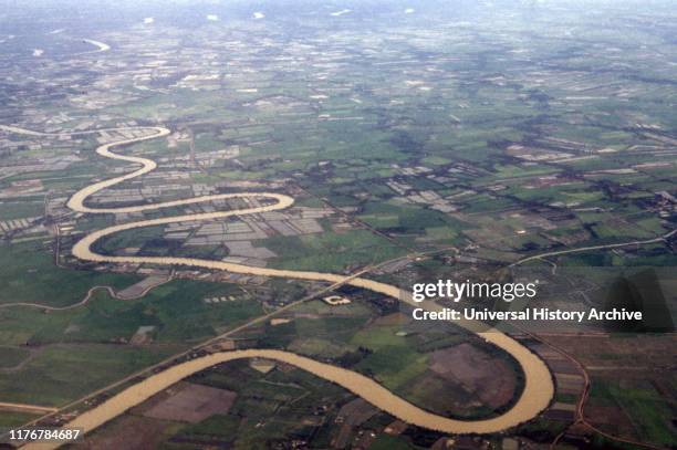 Vietnamese rice fields line the Mekong river as it passes through South Vietnam 2019.