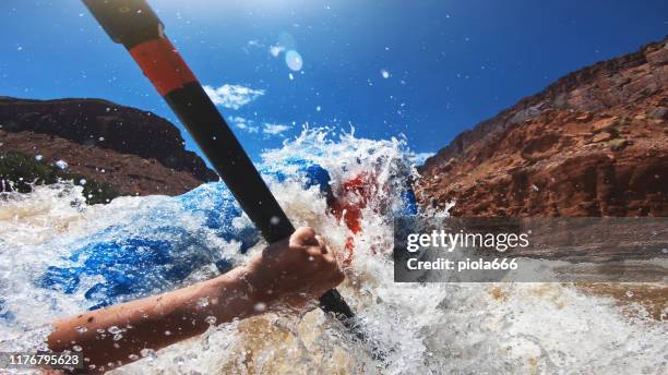 pov capsizing while rafting with kayak in colorado river - moab rafting stock pictures, royalty-free photos & images