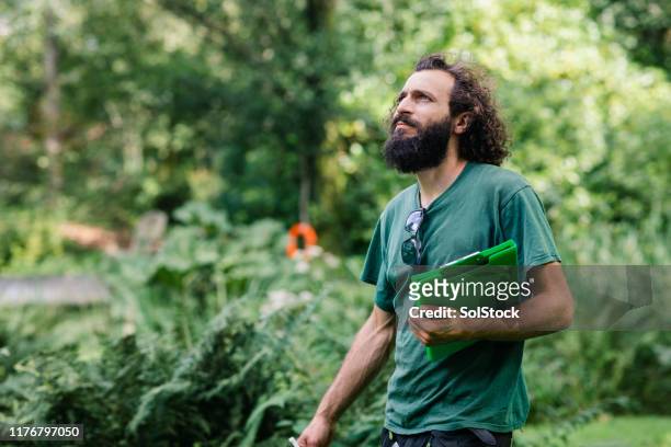 portrait of gardener with clipboard looking up - landscaped stock pictures, royalty-free photos & images