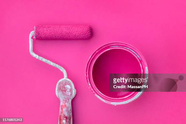 roller and paint can on fuchsia colored surface - pink paint stock pictures, royalty-free photos & images