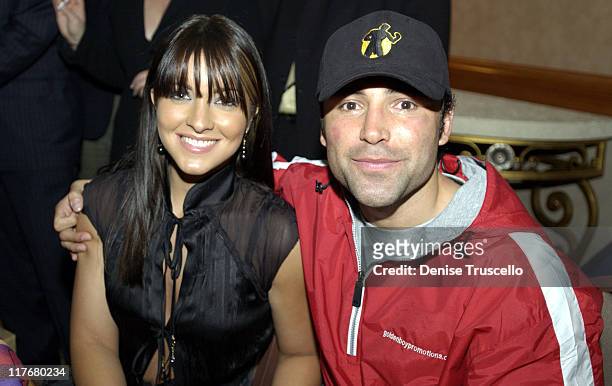 Featherweight Champion Oscar De La Hoya suffered a sprained hand during the fight seen here with his wife Millie as they celebrate the victory.