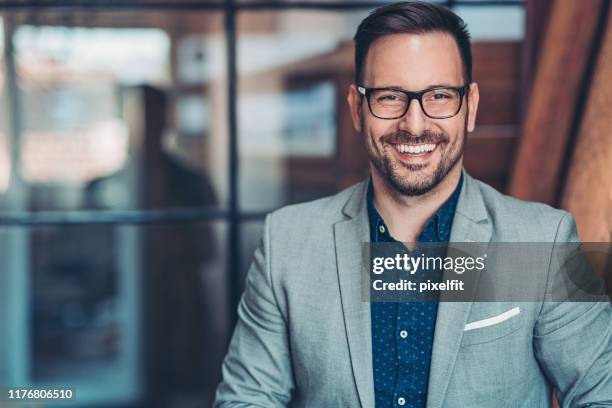 portrait of a smiling businessman - white jacket stock pictures, royalty-free photos & images