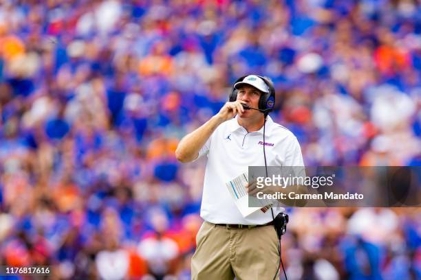 Head coach Dan Mullen of the Florida Gators speaks into his headset during the game against the Tennessee Volunteers at Ben Hill Griffin Stadium on...